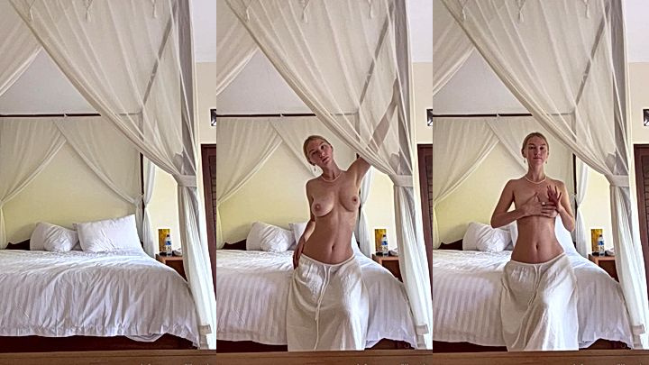 white naughty queen Lily Ivy stands talking with her big tits resting on her palm