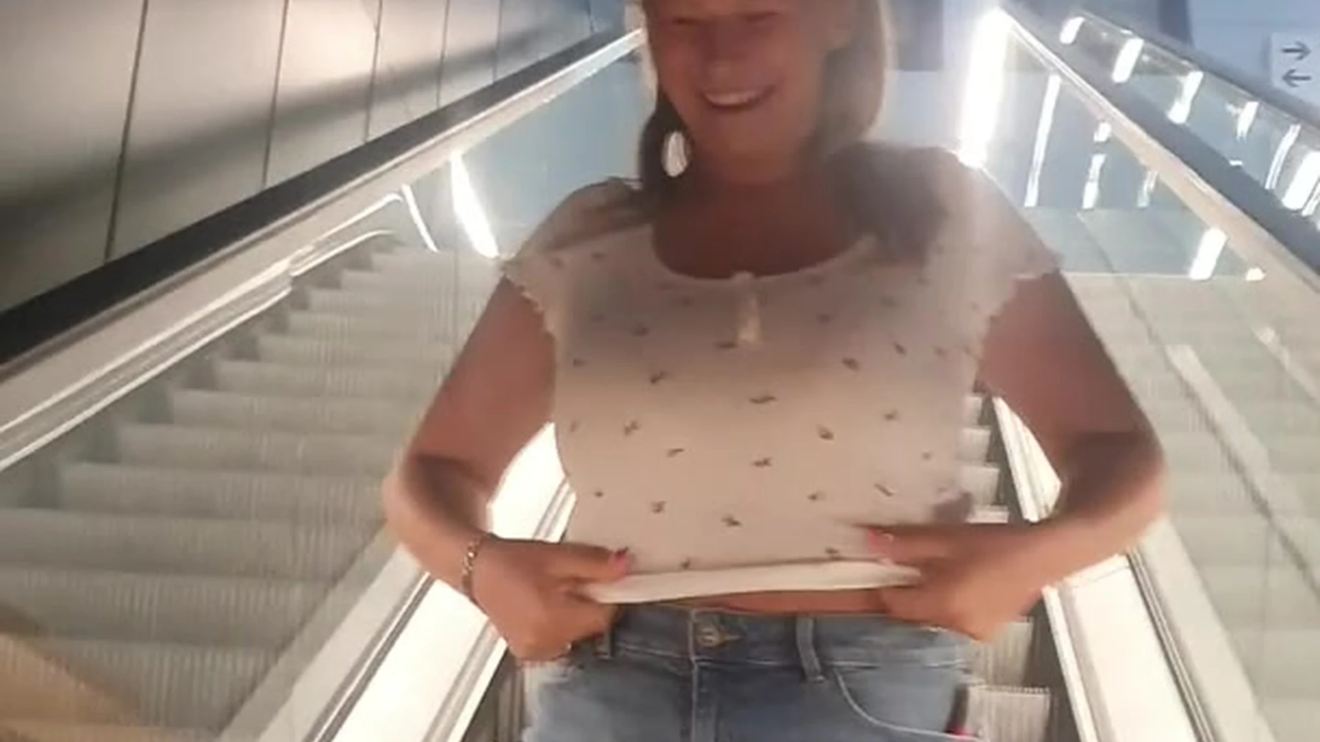 naughty model shows her big boobs on the escalator