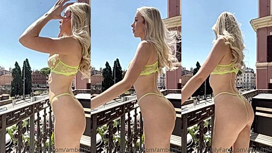 gorgeous slut Goddess Amber standing outside the sunlight shining on her